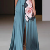 Éléa | Robe longue évasée sans manches à imprimé floral et fente subtile